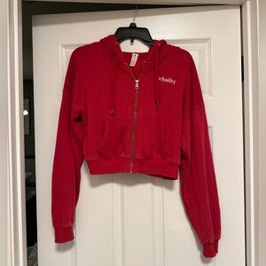 Vitality Mantra Zip in color ruby cherry. Size small